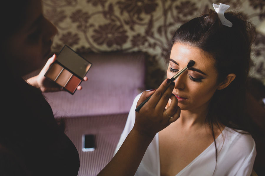 a bride having her makeup done