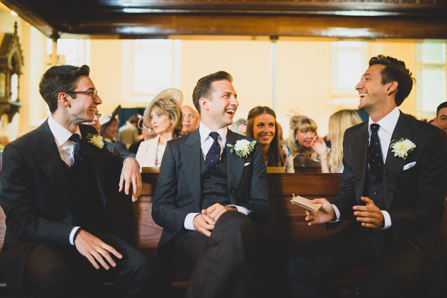 groom and brothers in church before wedding ceremony