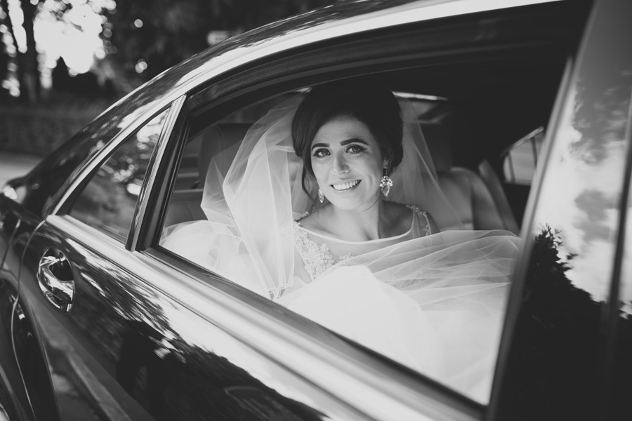 photo of the bride in the wedding car b&w
