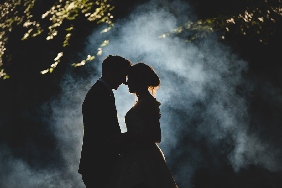 nunsmere hall wedding photography - the bride and groom with smoke