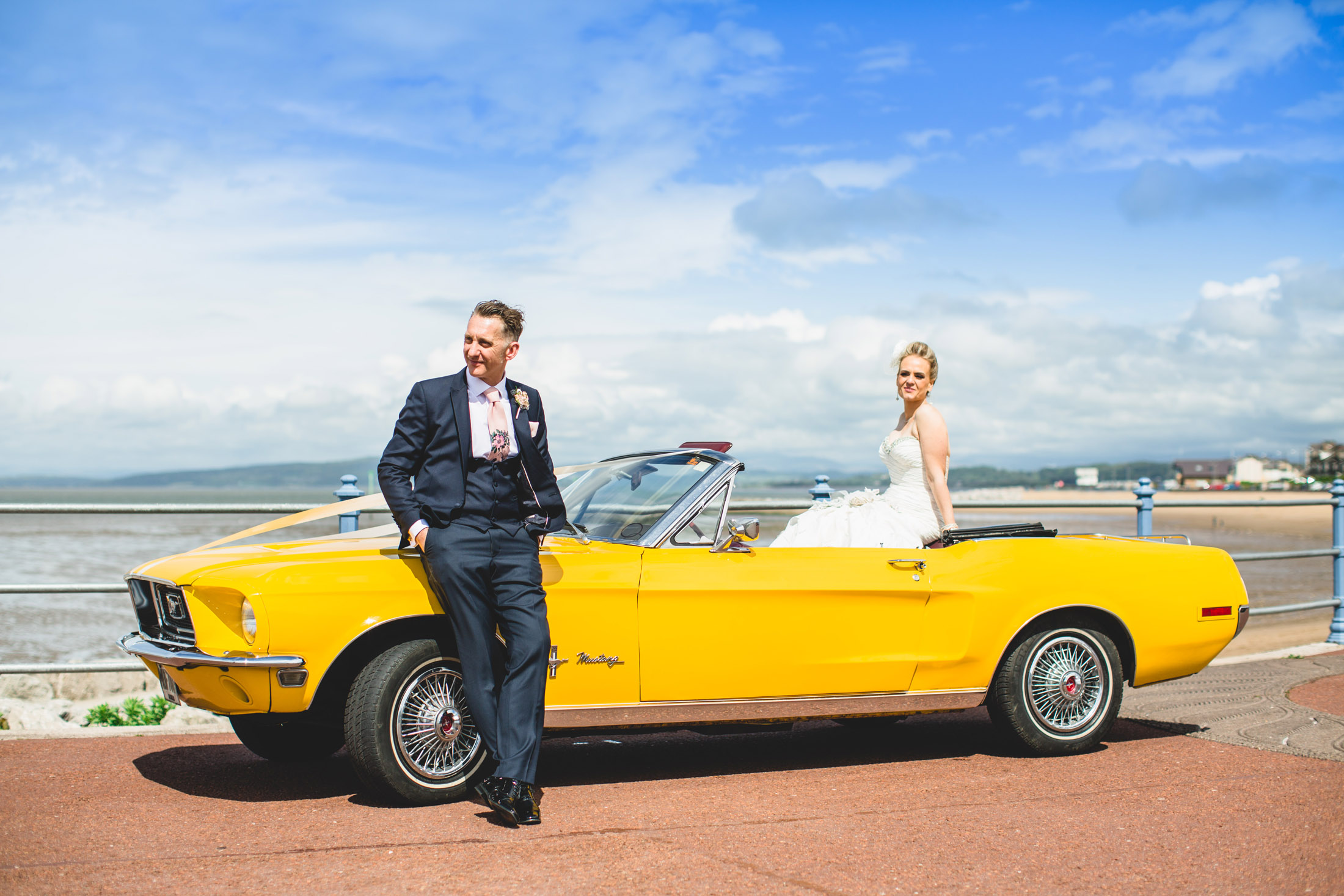 bride and groom with yellow mustang