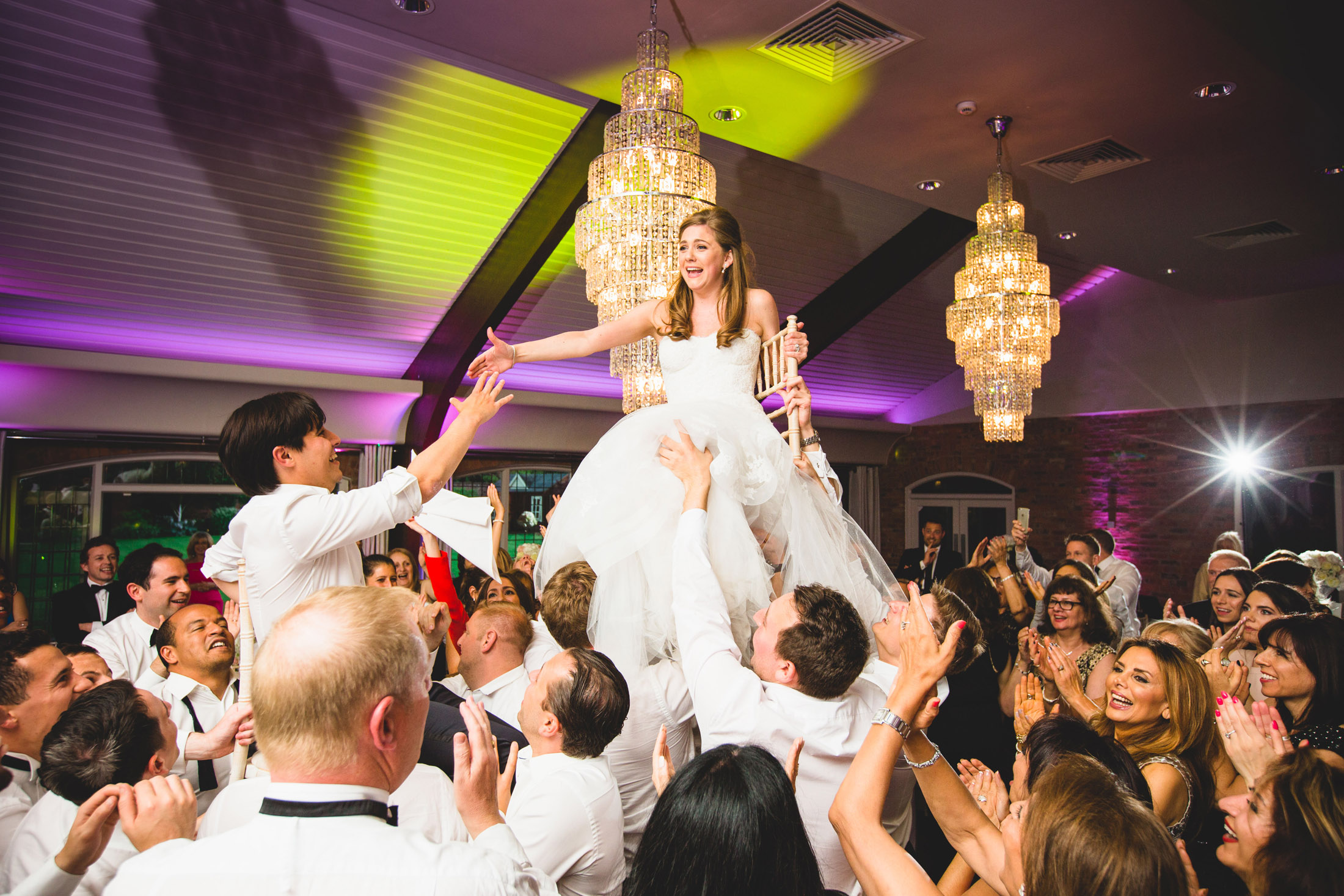 jewish wedding photography - dancing on chairs lifted up