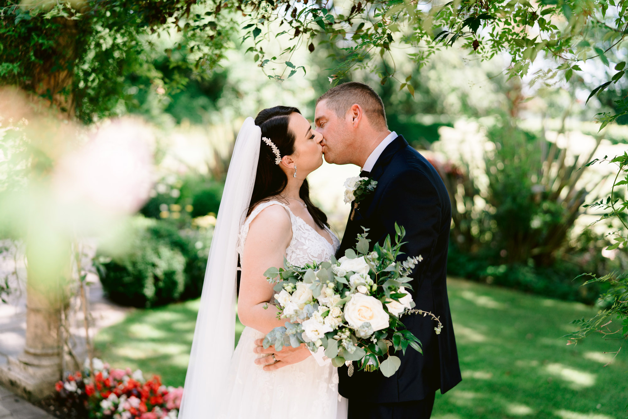 moxhull hall wedding photos bride and groom kissing in the gardens
