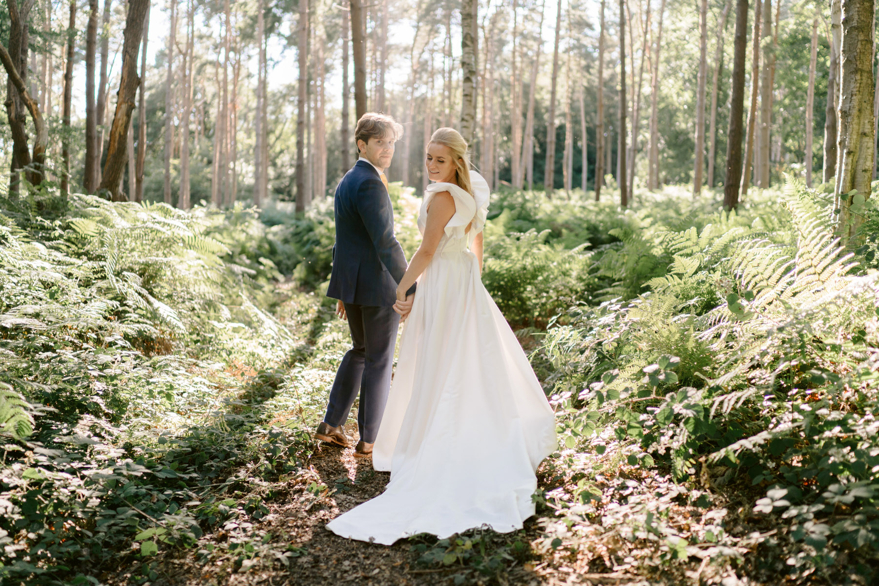 peckforton castle wedding photographer bride and groom in the woods looking towards camera creative shot