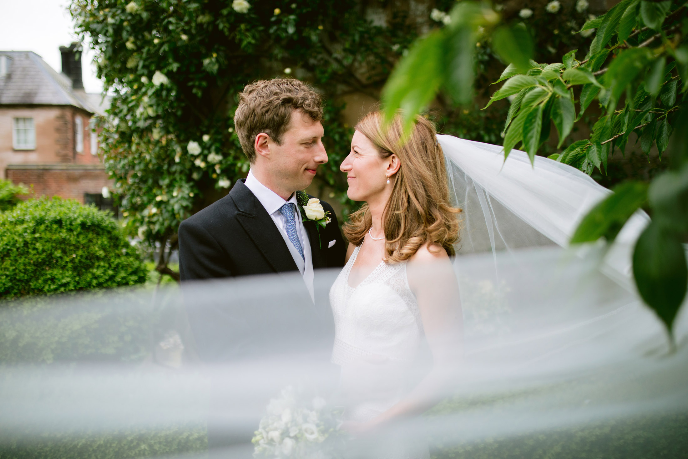 The brides veil is flowing in the wind at Capesthorne Hall