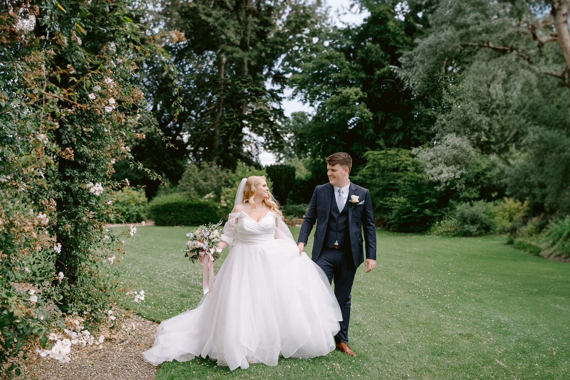 hawkstone hall wedding photography couple walkng in the rose gardens